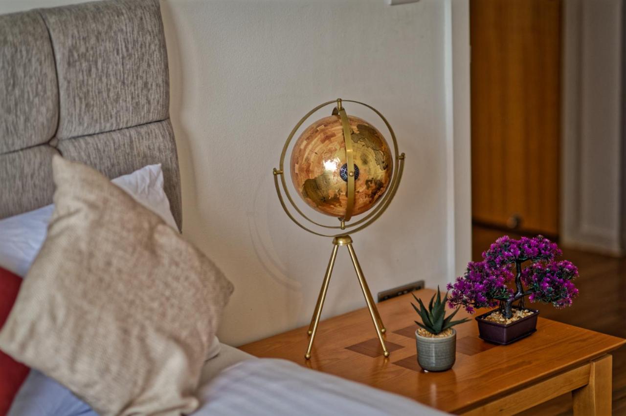 Bedroom with a globe ornament beside the bed at this Liverpool city centre apartment